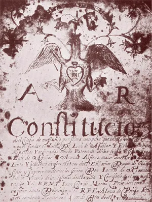Portada manuscrita, con orla y un escudo, de un libro titulado «Constituciones»